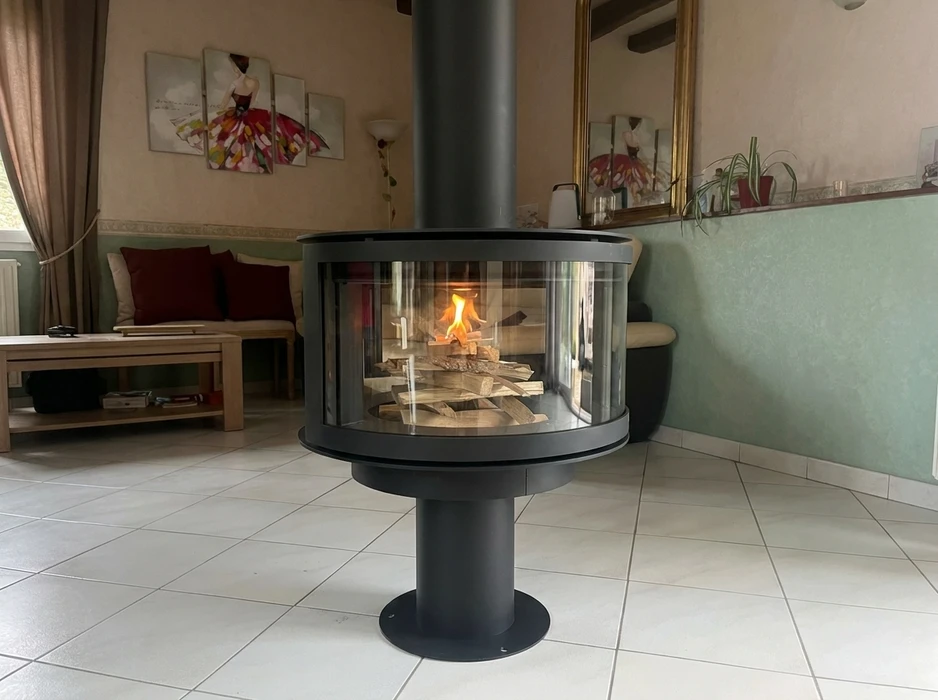 Poêle à granulés design de forme cylindrique, en émail blanc, vitré sur la façade avec flammes visibles